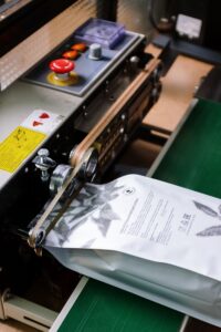Industrial machine sealing a coffee bag