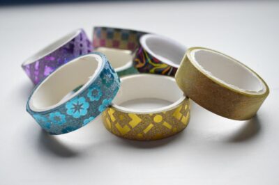 Assorted colored adhesive tape rolls arranged together