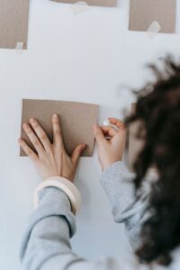 Mounting items on a wall using double-sided adhesive tape