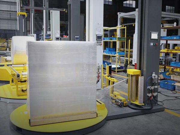 Pallet being wrapped with machine stretch film in a warehouse